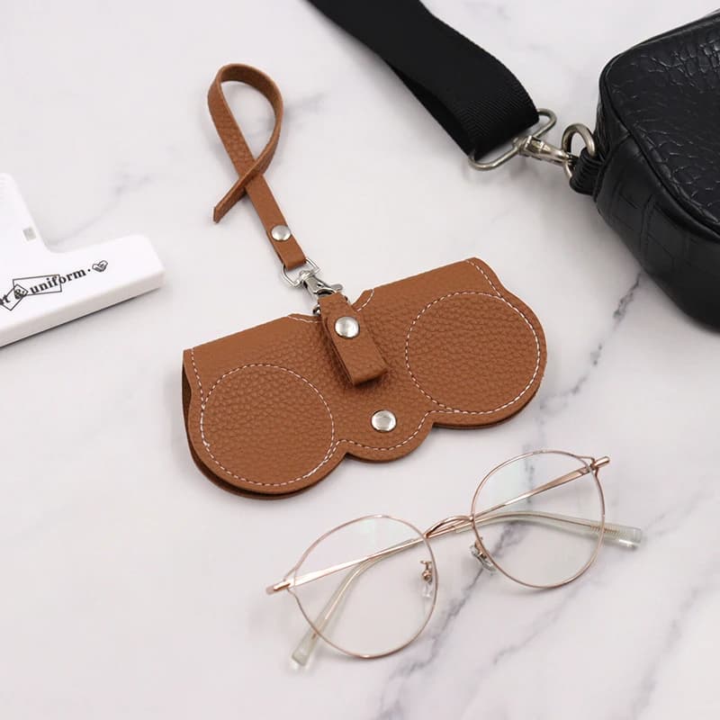 Nouveau sac de rangement de lunettes en cuir PU Portable mode lanière sac de lunettes de soleil étui